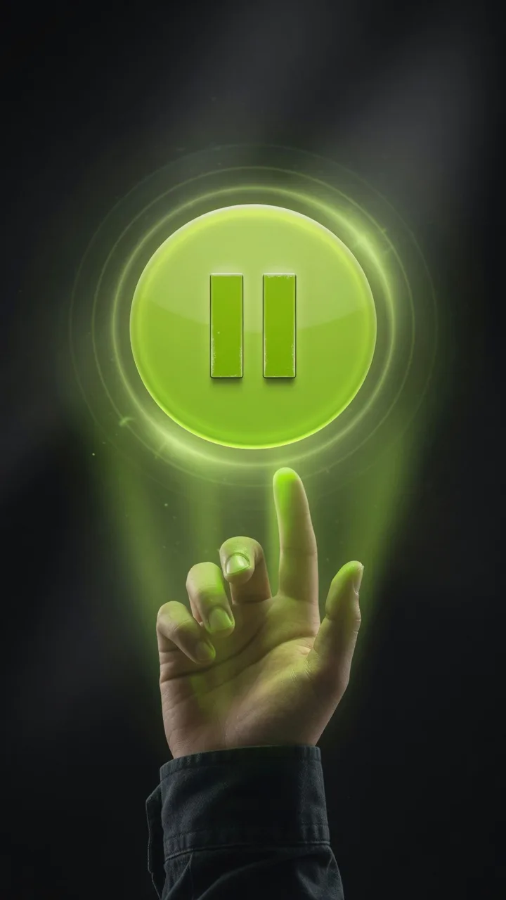 Hand reaching for a glowing pause control